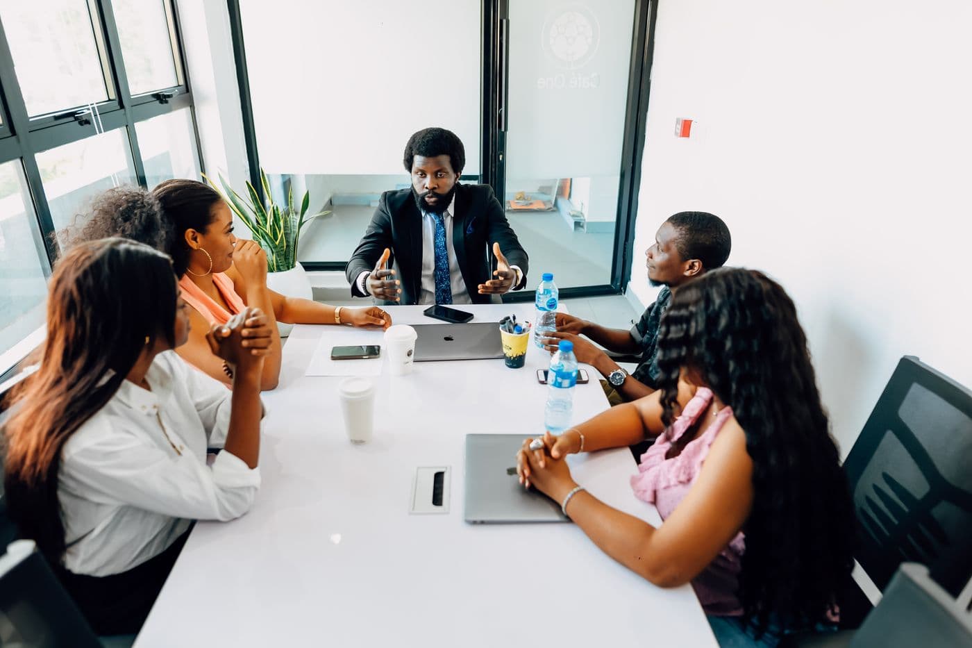 African professionals discussing a project in a meeting room.